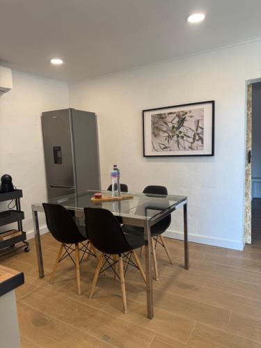 a dining room with a glass table and chairs at Casa Oliveira in Silves