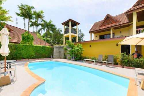 a swimming pool in the backyard of a house at Family Bungalow Kamala in Kamala Beach