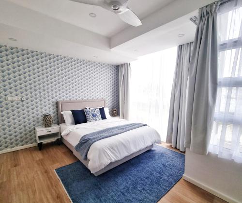 a bedroom with a bed and a blue rug at Astria Homes- your beach front home in Hulhumale