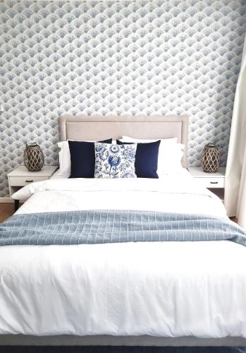 a bedroom with a large bed with a wall at Astria Homes- your beach front home in Hulhumale