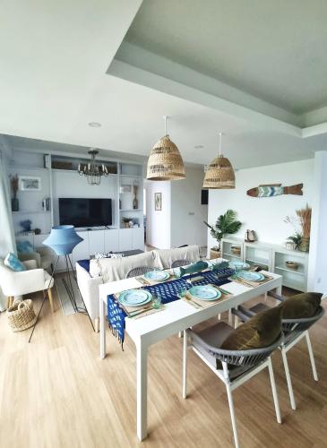 a living room with a white table and chairs at Astria Homes- your beach front home in Hulhumale