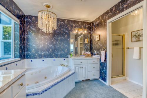 a bathroom with a tub and a sink and a mirror at Lakefront Oasis at Lake Stevens in Lake Stevens
