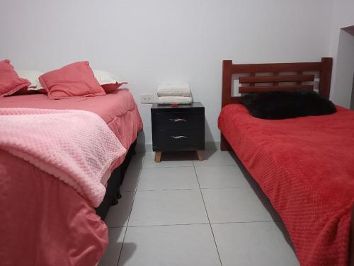 two beds sitting next to each other in a room at apartamento esmeralda zipaquira in Zipaquirá
