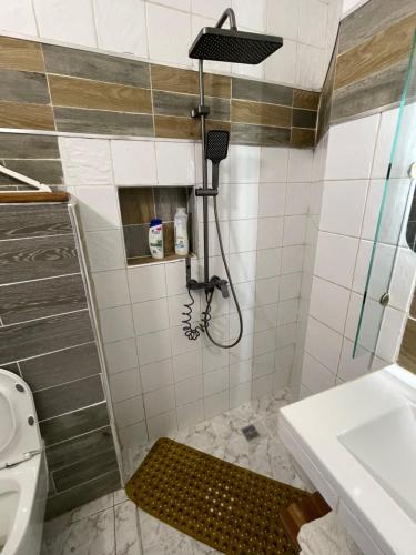 a bathroom with a shower and a toilet and a sink at Résidence d hôtes Minerva Mermoz in Dakar