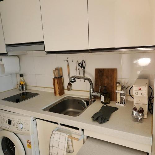 a kitchen with a sink and a washing machine at 을지대병원 둔산동 시청 정부청사역 법원근처 갤러리아백화점 성심당 하레하레 태평소국밥 3분컷 in Sŭngch'ŏn-ni