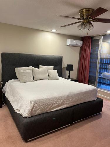 a bedroom with a large bed with a ceiling fan at Villa Providencia in Guadalajara