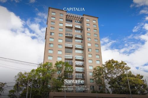 a tall building with a sign on top of it at Capitalia Santa Fe in Mexico City