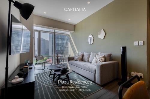 a living room with a couch and a table at Capitalia Plaza Residences Reforma in Mexico City