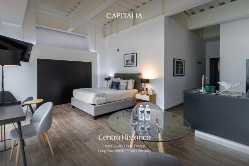 a bedroom with a bed and a glass table at Capitalia Centro Historico in Mexico City