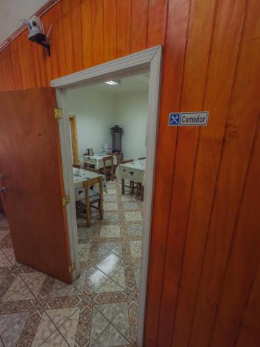 an open door to a room with a table at Hostal Antonella in Los Ángeles