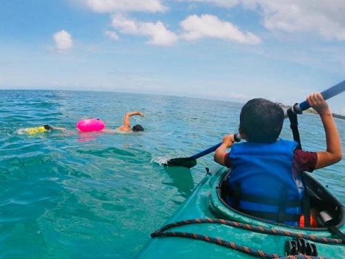 a person is in a kayak in the water at Beach Bungalow 100 m Playa Coson in Las Terrenas