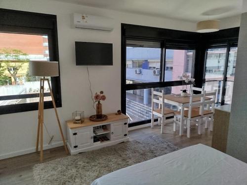 a bedroom with a bed and a dining room with a table at let health flow in Montevideo