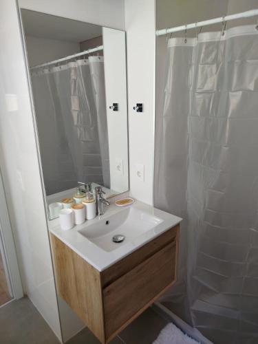 a bathroom with a white sink and a shower at let health flow in Montevideo