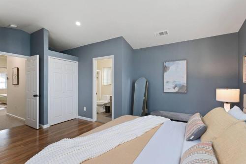 a bedroom with blue walls and a bed at Mid-century Riverview Haven W Waterfall Hot Tub! in Vallejo