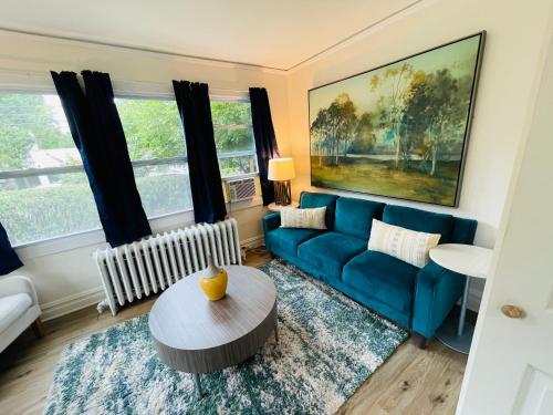 a living room with a blue couch and a table at GL- Great Location, Free Parking, Spacious, Private Office & Family Friendly in Evanston