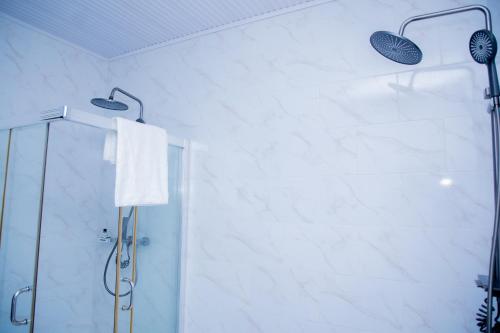 a shower in a bathroom with a glass shower stall at A Beautiful home, Kanombe, Nyarugunga in Kigali