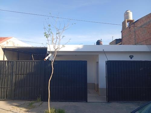 ein kleiner Baum vor einer Garage in der Unterkunft Alojamiento Valle del Sol in San Fernando del Valle de Catamarca