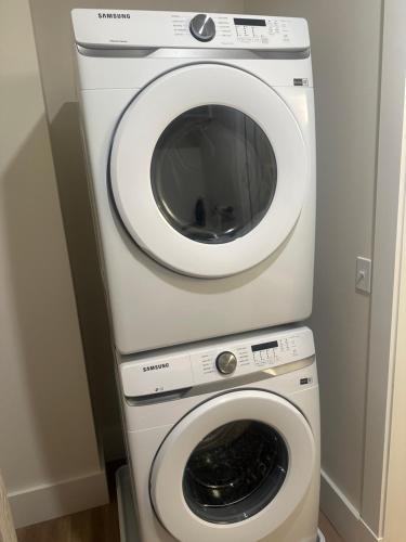 a washing machine and a dryer in a room at High Rise Downtown Apartment in South Bend