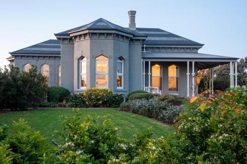 a house with a lawn in front of it at Mary MacKillop Spirituality Centre, St Joseph's by the sea in Williamstown