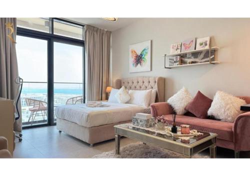 a living room with a bed and a couch at Soho Saadiyat Island Poolside Luxury Retreat - Moments from Louvre Abu Dhabi in Abu Dhabi