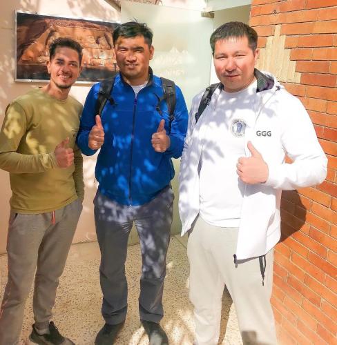 a group of three men giving thumbs up at Farida Pyramids ŌTEL in Cairo