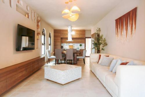 a living room with a couch and a table at Unique Villa with private pool in Mayaguez in Mayaguez