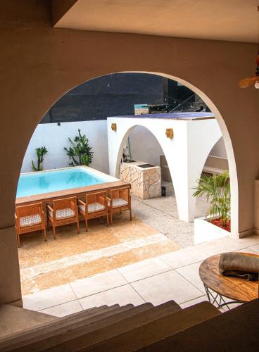 a swimming pool in a house with an archway at Unique Villa with private pool in Mayaguez in Mayaguez
