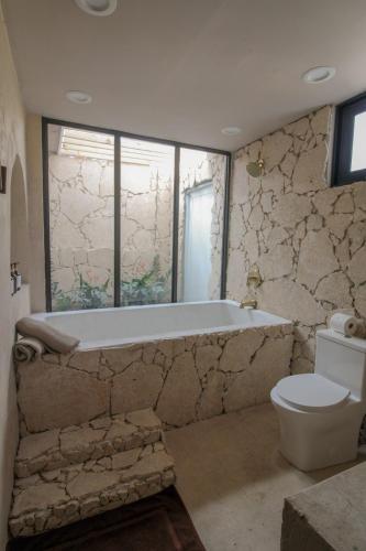 a bathroom with a bath tub and a toilet at Unique Villa with private pool in Mayaguez in Mayaguez