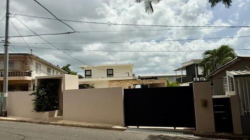 a black and white fence in front of some houses at Unique Villa with private pool in Mayaguez in Mayaguez