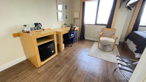a room with a desk and a bedroom with a bed at Espaço Aeroporto de Congonhas in Sao Paulo