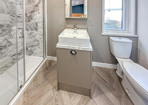 a bathroom with a sink and a toilet and a shower at Watermill Leisure Park in Moortown