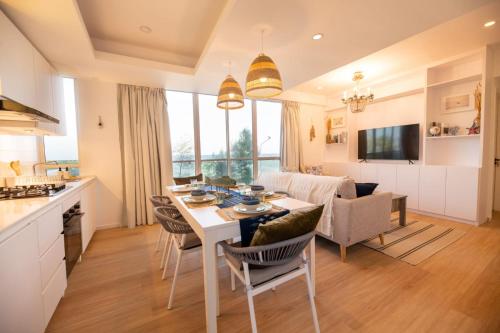 a kitchen and living room with a table and chairs at Astria Homes- your beach front home in Hulhumale