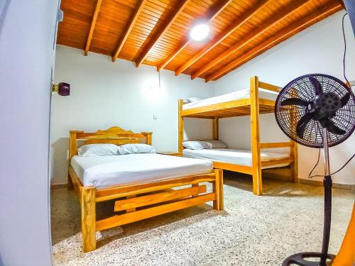 a room with two bunk beds and a fan at Hotelobelisq in Medellín