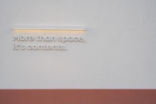 a white wall with a sign that says more than space its contents at Aank Hotel Ilsan in Goyang