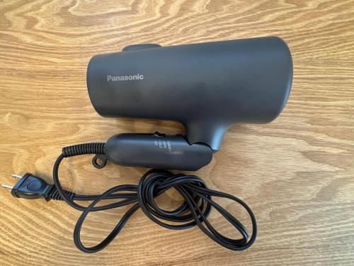 a hair dryer with a cord on a wooden table at Maxim 2-B in Naha