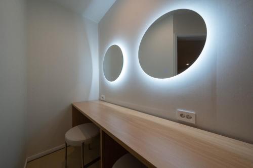 a bathroom with a vanity with a mirror on the wall at Aank Hotel Ilsan in Goyang