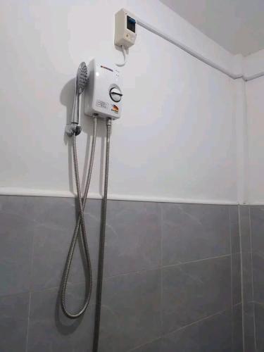 a blow dryer in a shower in a bathroom at NELU GUEST HOUSE in Panglao Island