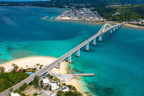 an aerial view of a bridge over a beach at 本部町Mio Styleは美ら海水族館まで10分の好立地の一棟貸BBQ可能 in Motobu