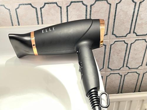 a black hair dryer sitting on top of a table at - - - - - Au Sixième Ciel - - - - - in Brussels