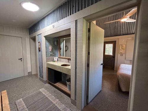 a bathroom with a sink and a mirror at The Headwaters Eco Lodge in Glenorchy