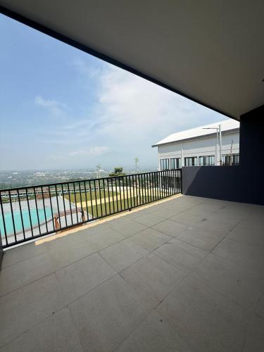 an empty balcony with a view of the ocean at Wind Hill Mountain View Resort in Gununggeulis