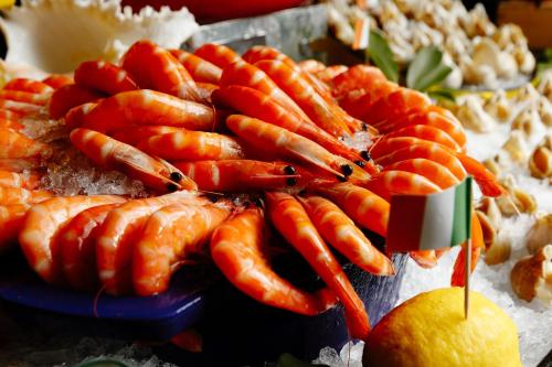 a bunch of carrots on a plate with a lemon at Vignette Collection The Xanadu Guangzhou, an IHG Hotel in Guangzhou