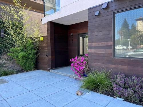 a house with purple flowers on the side of it at 906 Brand new townhome sleeps 10 in Redwood City