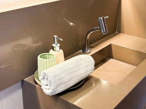 ein Waschbecken mit einem weißen Handtuch darin in der Unterkunft Bangalô Essenza do Sol |Luxo & Charme em Carneiros in Tamandaré