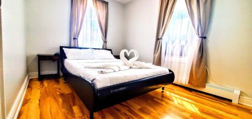 a bedroom with a bed with a heart decoration on it at 2 BR Apt|15 Min to NYC|Book Today in North Bergen