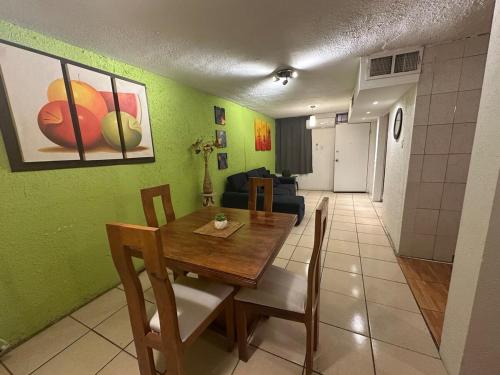 a dining room with a table and a living room at House by American Consulate Cd in Manuel F. Martínez