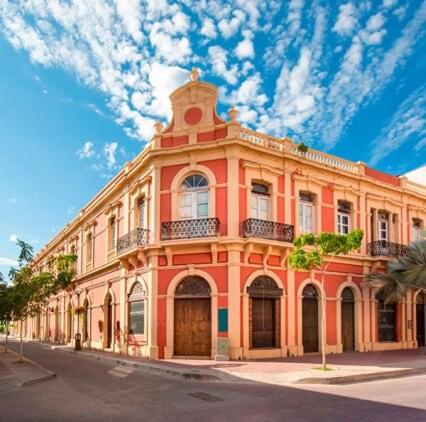 a large orange building on the side of a street at Casa al Mare in Mazatlán