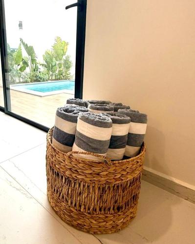 a stack of towels in a basket on the floor at Casa al Mare in Mazatlán
