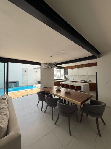 a kitchen and dining room with a table and a couch at Casa al Mare in Mazatlán