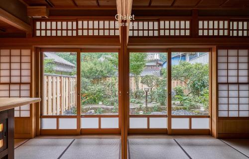 an empty room with a large window in a building at Craft Inn WARAKU in Shizuoka